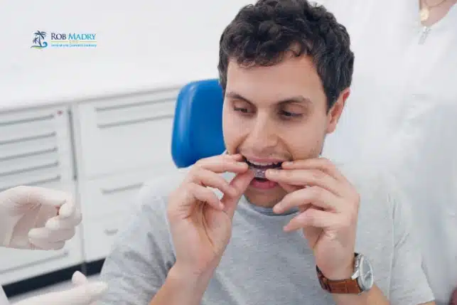 Adult patient using Invisalign clear aligners at dental visit for Can Adults Get Invisalign treatment at Rob Madry DDS