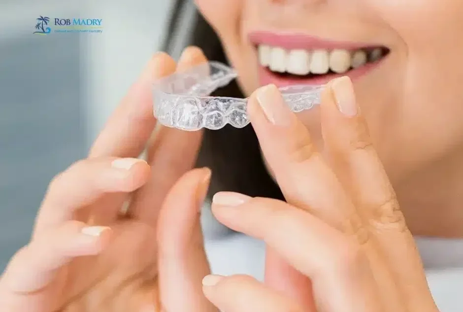 Invisalign for adults in Corpus Christi with a clear aligner being placed over teeth